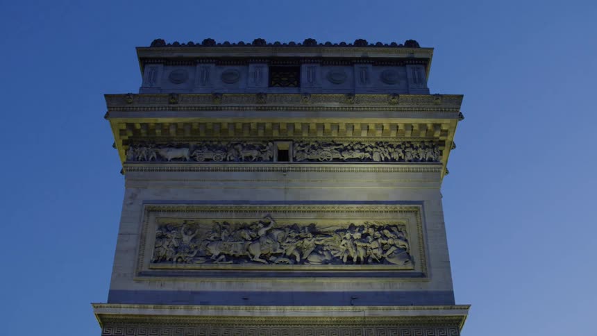Top architecture of arc de triomphe in paris with darkened sky