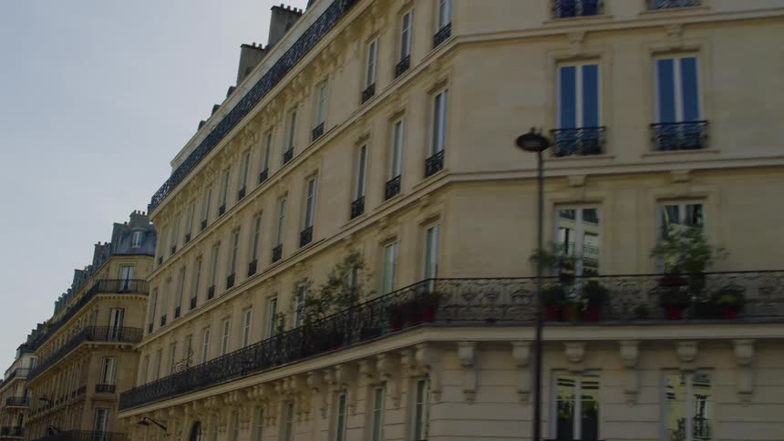 Evening scene of a welllit elegant building facade in an european city