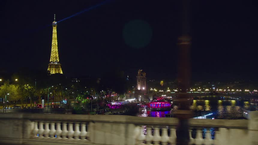 The eiffel tower is shining at night