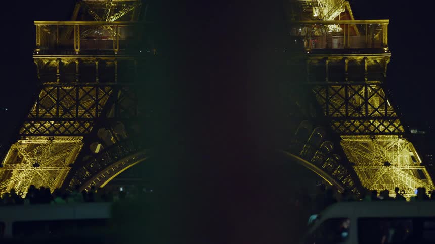 Crowd of people in front of the eiffel tower at night