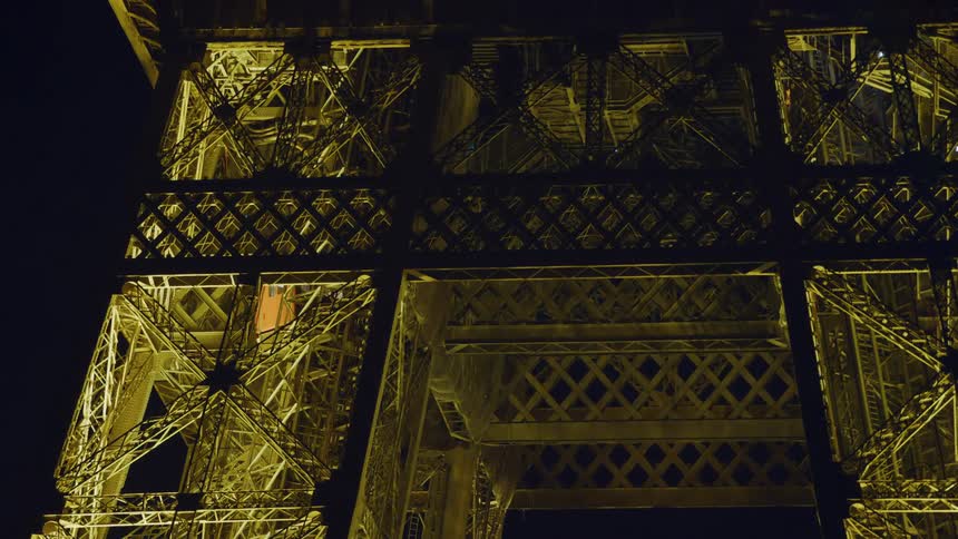 Elevator going up the eiffel tower at night