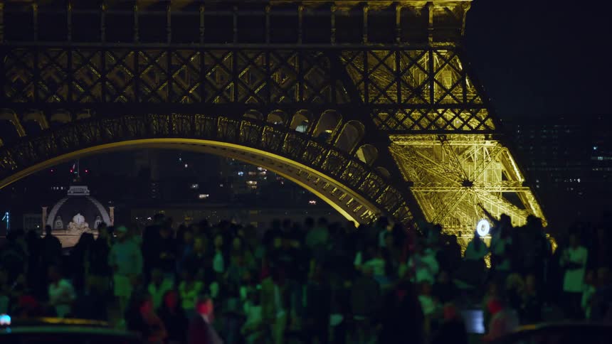 A crowd is celebrating outside the eiffel tower