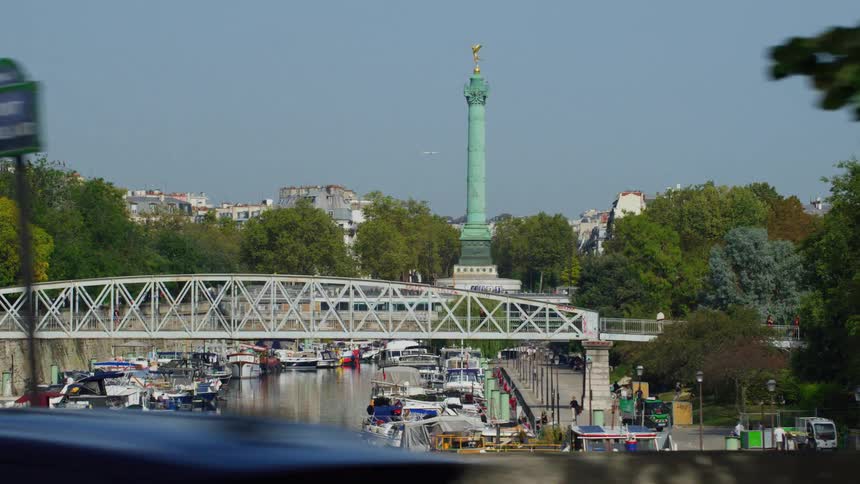 Landscape of a canal and a lake with a bridge embargos attacked with the artistic monument in a metropolis