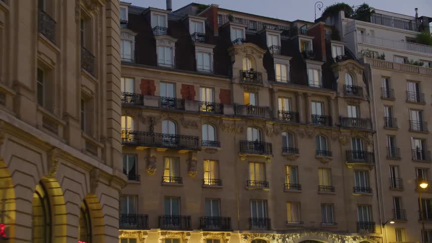 Evening scene of a welllit elegant building facade in an european city