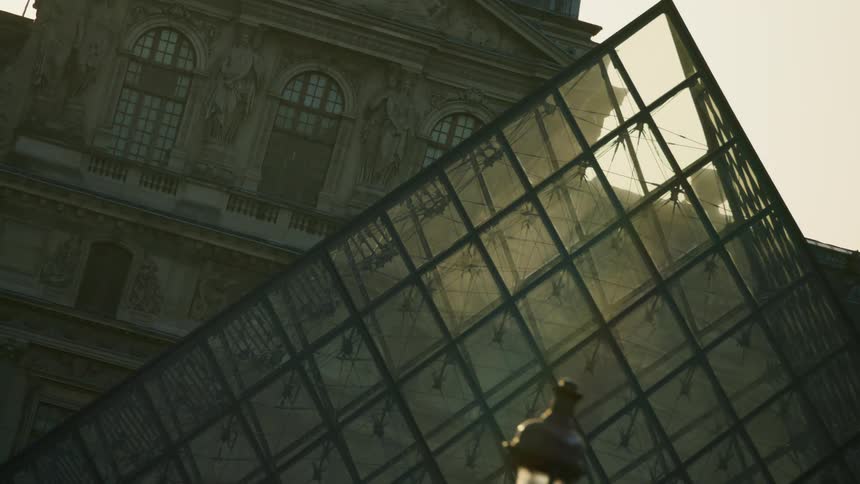 Museum of a triangularshaped mirrored pyramid in the middle of a city square