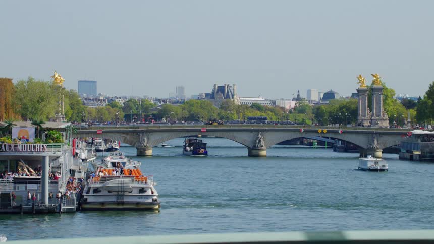 Boats travel under the bridge in the city