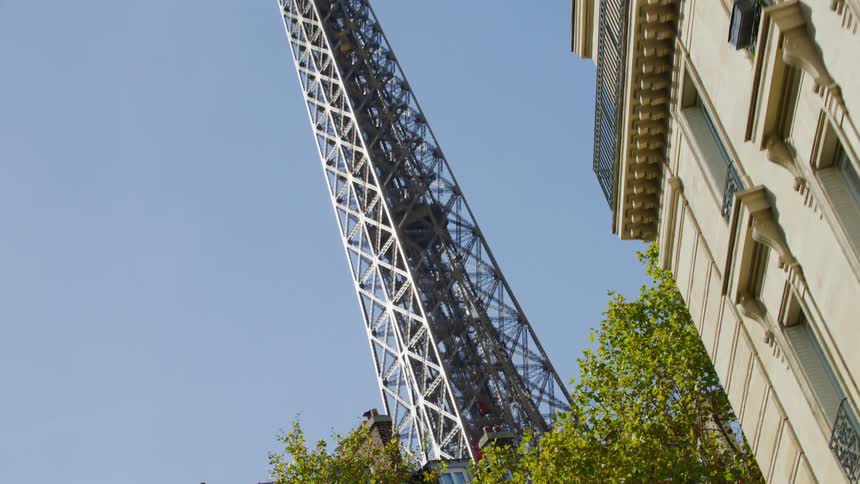 The eiffel tower rises high into the clear sky
