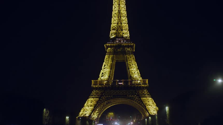 Crowd of people around the eiffel tower at night