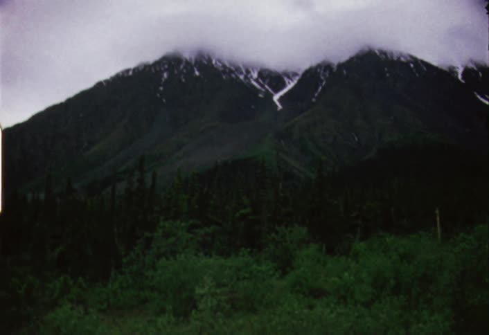 Dark clouds hovering at the snowy mountaintops