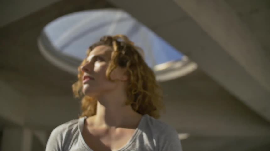Woman with curly hair looking towards the distance