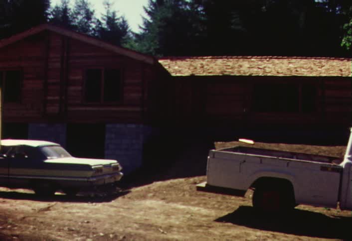 Vintage vehicles sitting outside a few buildings