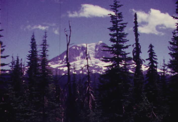 Snowy mountain in the distance on a partly cloudy day