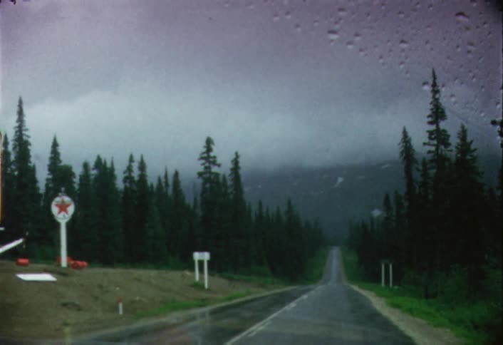 The windshield wipers are working in this car traveling in the rain