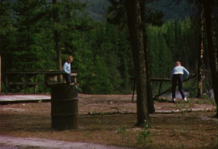 Boys playing next to a river