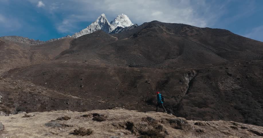 A man hikes on a mountain