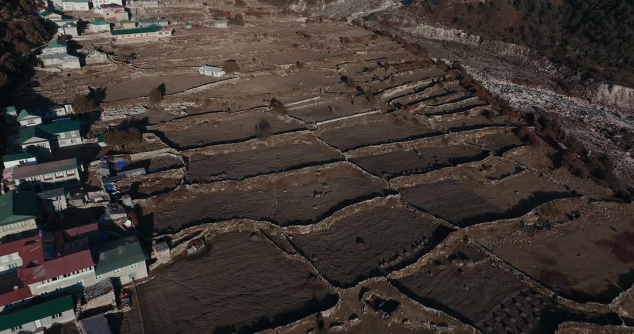 Village and agriculture carried out on a mountain with solar reflection