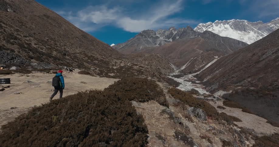 A man hikes along a mountain plateau