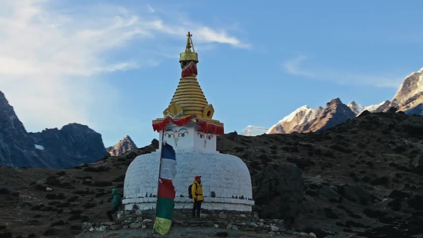 People in a temple in the mountains at sunset on a cold day