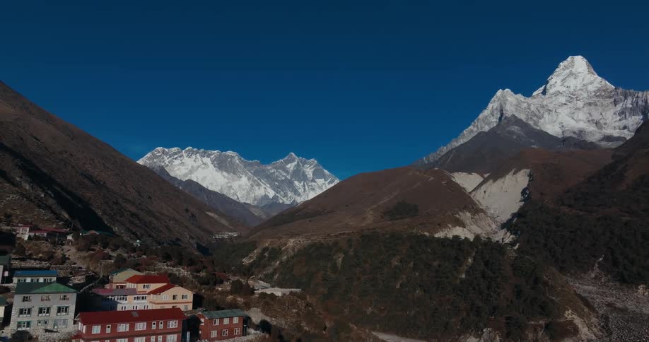 Village in the middle of hills surrounded by mountains