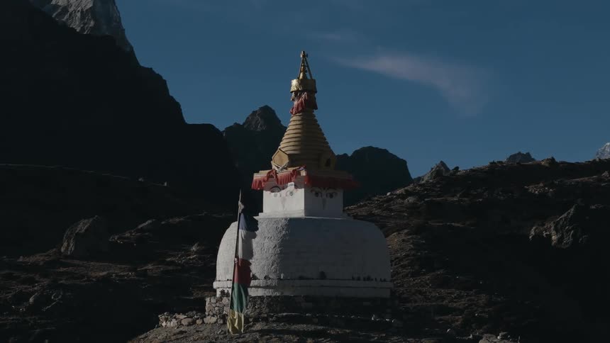 A small monument is constructed high up in a mountain range