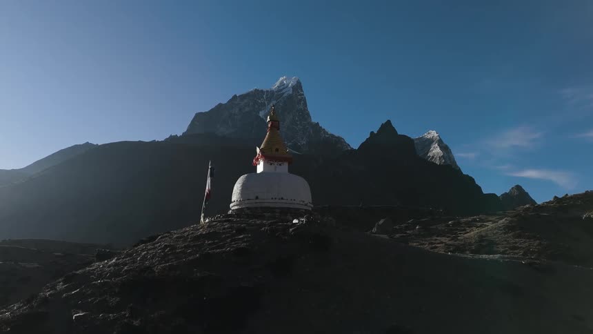 A small shelter is on top of the mountain