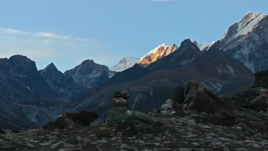 A man with backpack walking on mountain at daytime