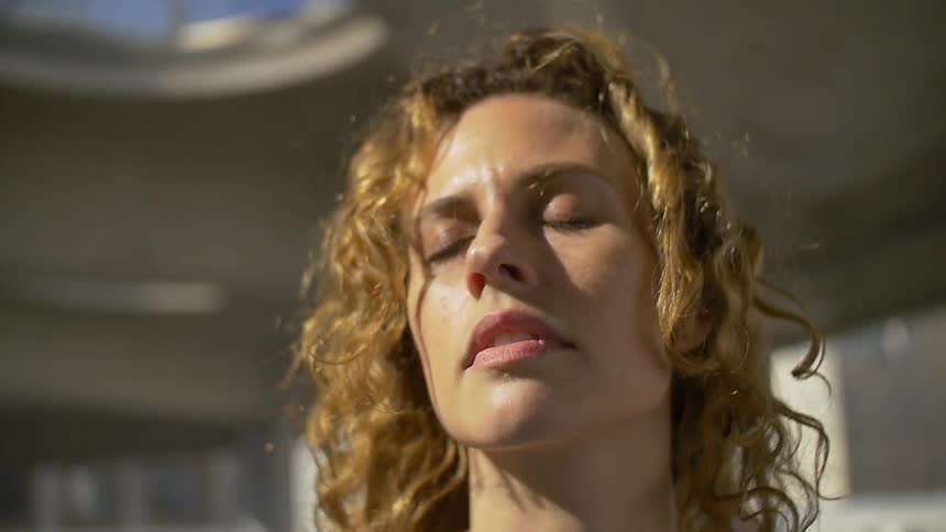 Woman outside with eyes closed on windy day