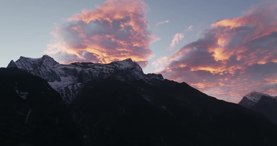 Aerial of a mountain range during an orange sunset