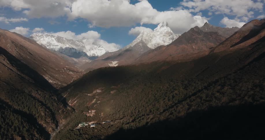 Aerial of a village in a mountain valley during the day