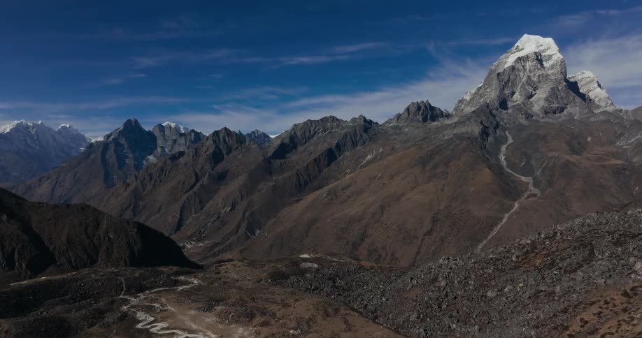 A large valley next to a mountain range