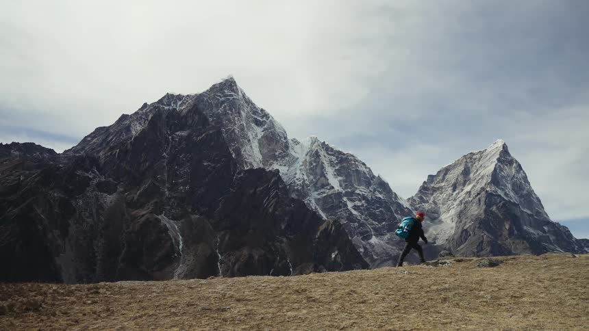 A man walking in a mountain valley