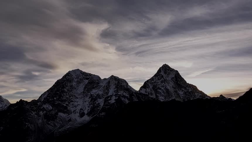 Thick clouds move over mountains