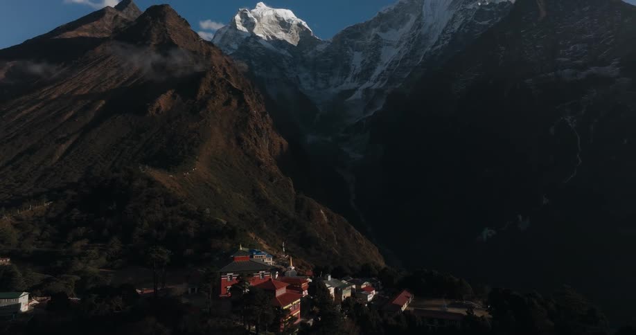 Village in the middle of mountains with solar reflection in winter