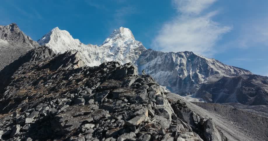Aerial of a snowy mountain range on a sunny day