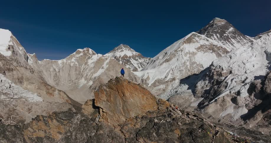 Someone standing on a mountain after walking for a while at midday