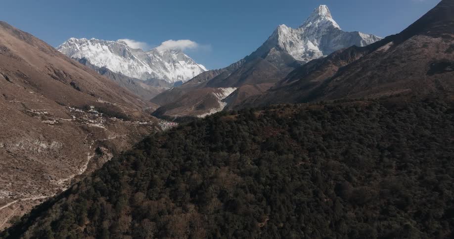 A small village sits in the shadow of mountains