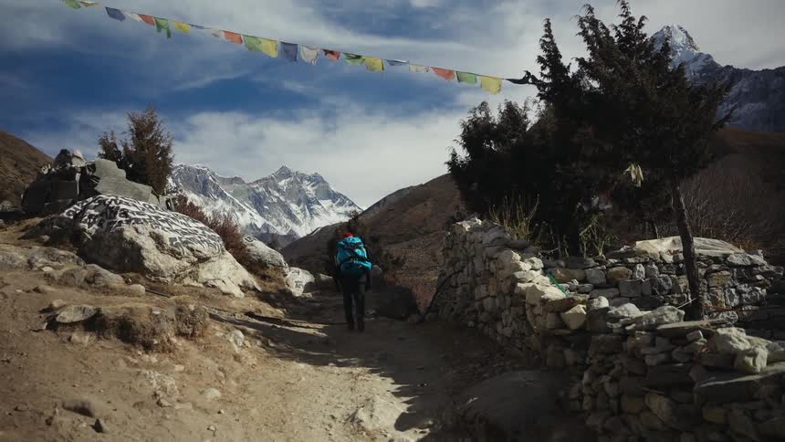Man walking on a mountain in a village in winter