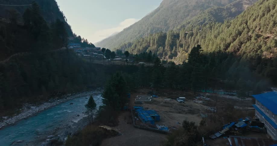 A small town sits next to a river in a valley