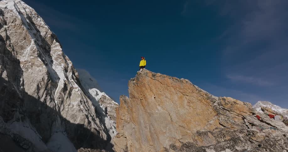 A man stands on mountain outcropping