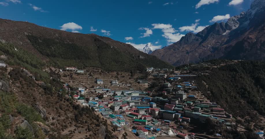 An aerial view of a community of homes in a mountain range