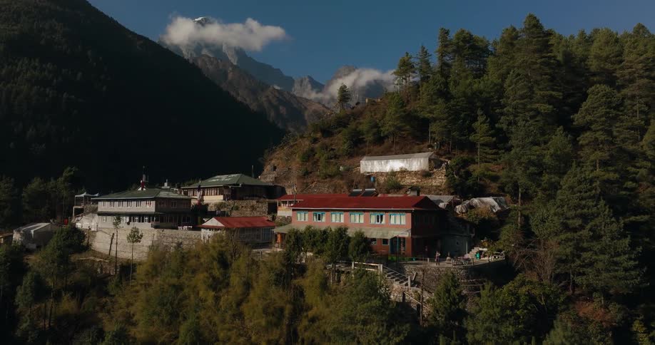 Aerial of a wooded mountain village on a sunny day