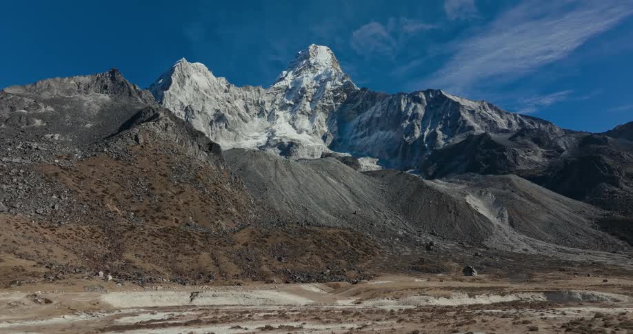 Rocky mountains with peaks covered by snow in daylight