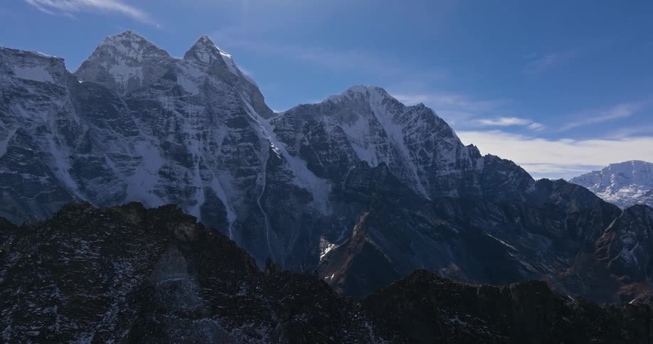 Natural landscape of mountains with peaks covered by snow in daylight