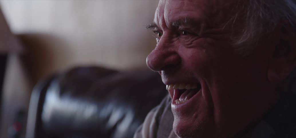 A man laughing and having fun at home