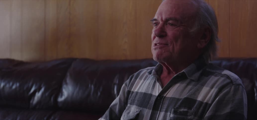 An old man celebrates as he plays console games