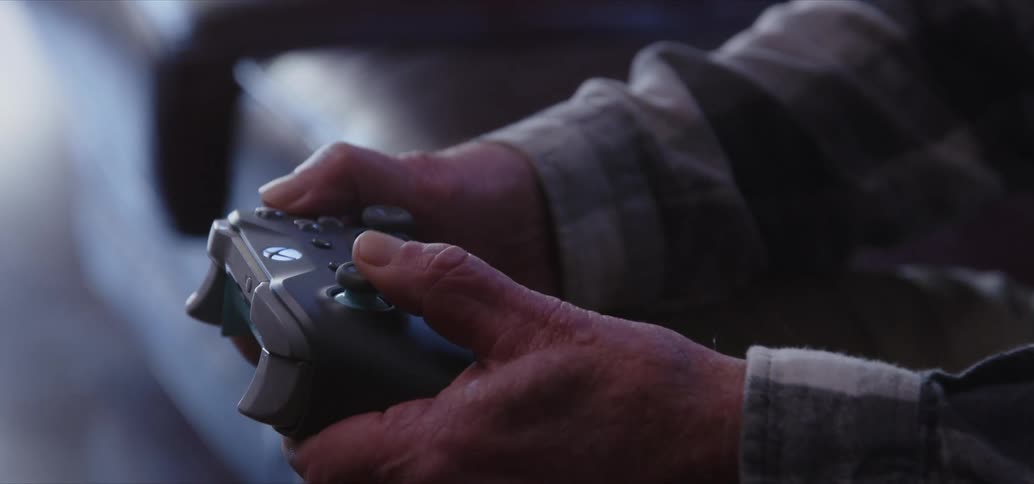 Hands pressing buttons on a video game controller