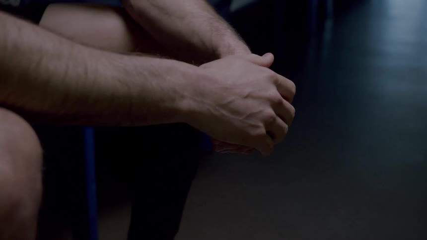 A person sitting rubbing their hands