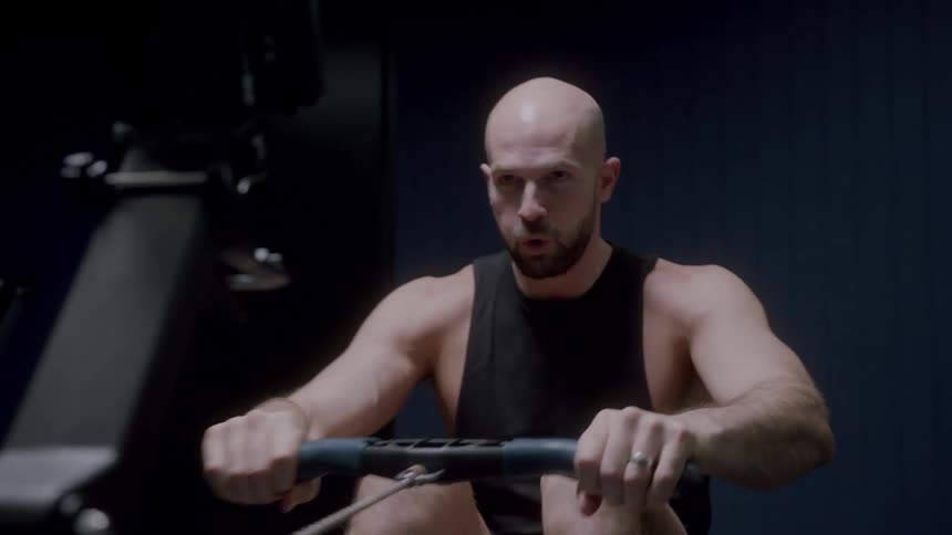 A man doing some rowing exercises in a gym