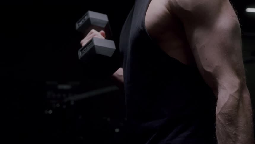 A man is lifting dumbbells