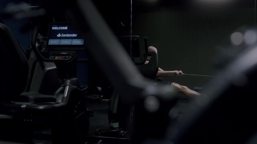 A man working out alone in a gym at night